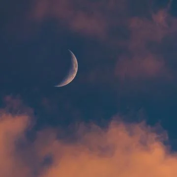 Sunset sky with large crescent moon, evening sky background Fotos Stock