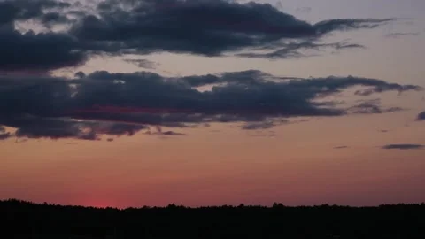 Sunset sky with moving clouds over the forest on horizon time lapse Stock Footage 282587157