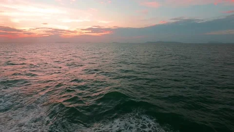 Sunset sky n pink cloud over sea water n ocean wave Stock Footage 153899253