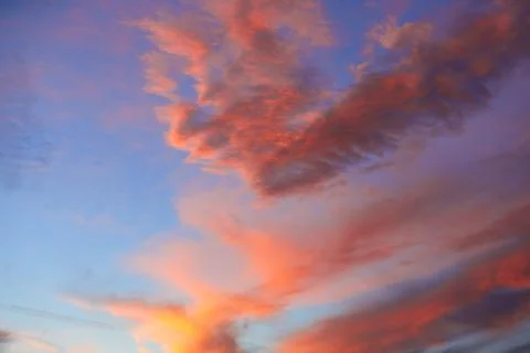 Sunset sky with orange clouds over blue Stock Photos