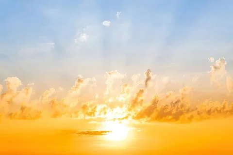 Sunset sky with orange clouds over a calm ocean Stock Photos