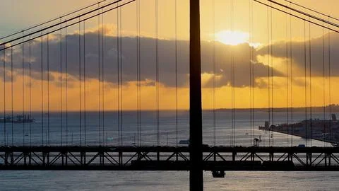 Sunset sky over 25 of April Bridge at Lisbon in Lisbon District Portugal. Fotos Stock
