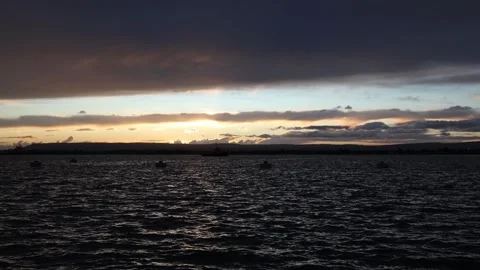 Sunset sky over dark water creating a calm evening mood Stock Footage 328286661