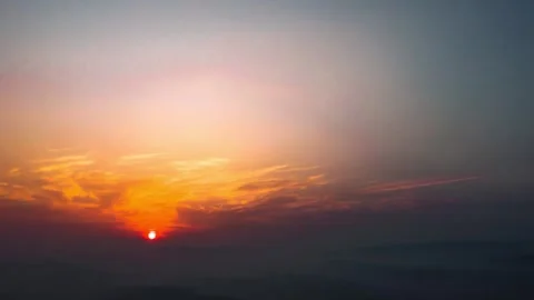 Sunset Sky Over Distant Mountains with Golden and Orange Clouds Stock Footage 342250034