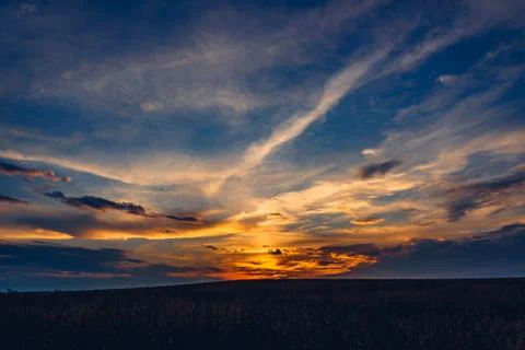 Sunset sky over the field Stock Photos