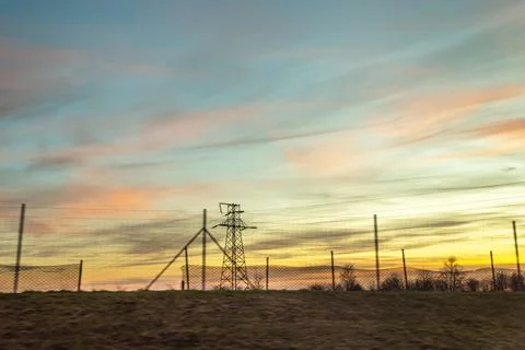 Sunset sky over the field, power line, photos from the car Stock Photos