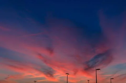 Sunset sky over lights Stock Photos