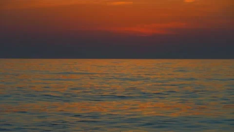 Sunset sky over sea in evening with colorful clouds of orange sunlight. Stock Footage 191539336