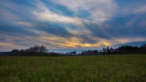 Sunset sky over wild meadow, 4k time lapse Stock Footage 83571645