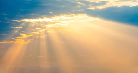 Sunset sky panorama with sun rays through clouds Fotos Stock