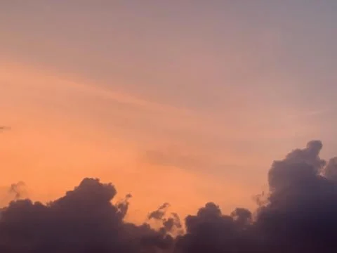 Sunset Sky with Pink Orange Gradient and Dark Clouds Silhouette Stock Photos