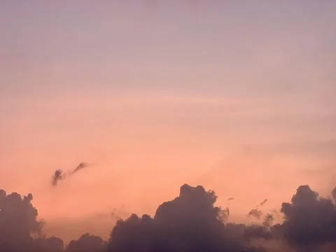 Sunset Sky with Pink Orange Gradient and Dark Clouds Silhouette Stock Photos