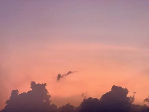 Sunset Sky with Pink Orange Gradient and Dark Clouds Silhouette Stock Photos