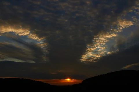 Sunset sky with punch hole clouds Stock Photos