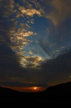 Sunset sky with punch hole clouds Stock Photos