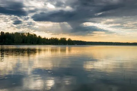 Sunset sky with rain cloud on the lake. Stock Photos