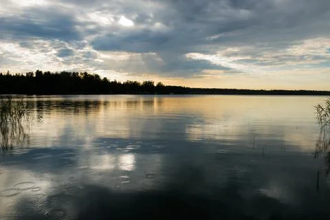 Sunset sky with rain cloud on the lake. Stock Photos