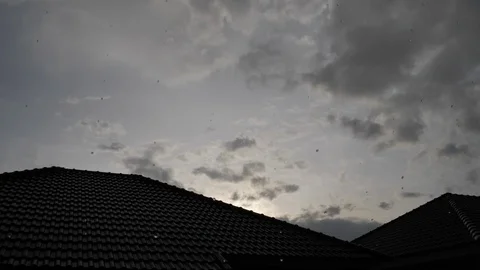Sunset sky in rainy day scene, slow motion water pouring rain falling on roof Stock Footage 94172840