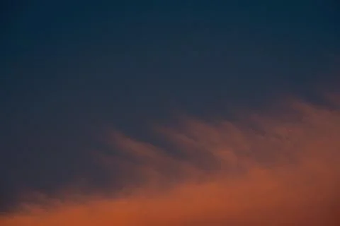 Sunset sky. Red clouds in a blue sky. Stock Photos