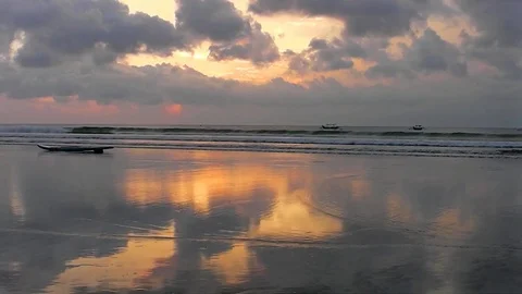The sunset sky is reflected in the mirror beach of Kuta. Video stock 81536727