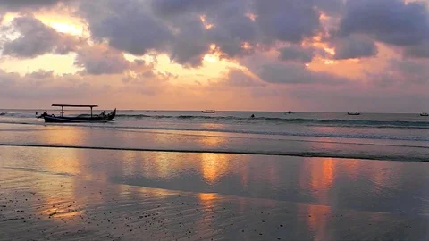The sunset sky is reflected in the mirror beach of Kuta. Video stock 81536729