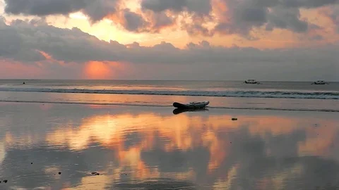 The sunset sky is reflected in the mirror beach of Kuta. Video stock 81536731