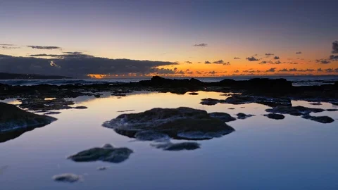 Sunset sky reflecting in rocky ocean coast pool. Beach near Punta del Hidalgo 스톡 동영상 123969729