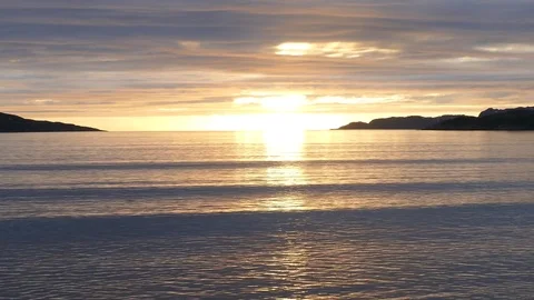 The sunset sky reflects in calm cold sea waves. Stock Footage 81726724