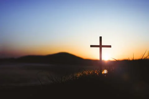 The sunset sky strong light and the holy cross of Jesus Christ Stock Photos
