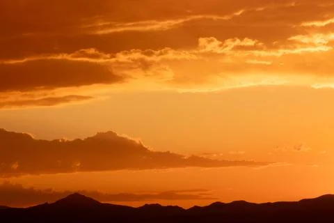 Sunset sky with stunning clouds in the background. Horizontal banner, story. Stock Photos