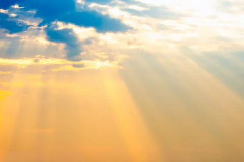 Sunset sky with sun rays through clouds Fotos Stock