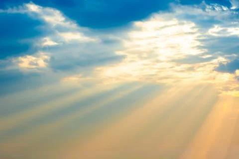Sunset sky with sun rays through clouds Fotos Stock