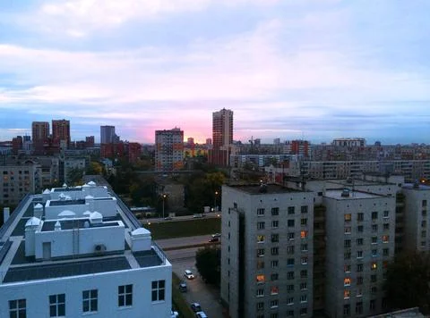 Sunset skyline of modern town with horizon Stock Photos