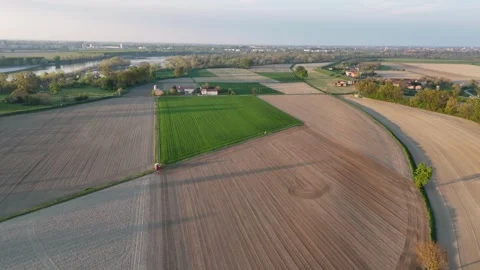 Sunset slow motion drone over patchwork fields by Po River at Olza di Stock Footage 308443513