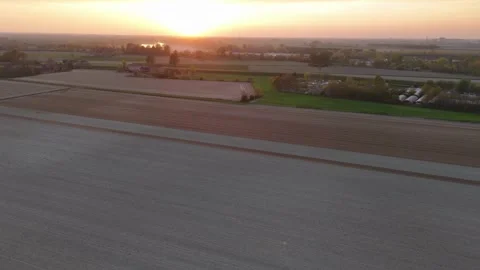 Sunset slow-motion drone pan over pre-seeded fields near Olza di Castelvetro Stock Footage 308444083