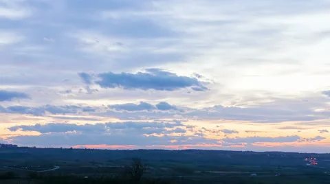 Sunset with slow moving clouds and traffic on highway Stock Footage 54763360