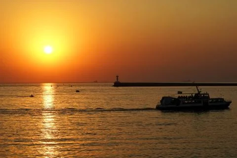 Sunset with small boat Stock Photos