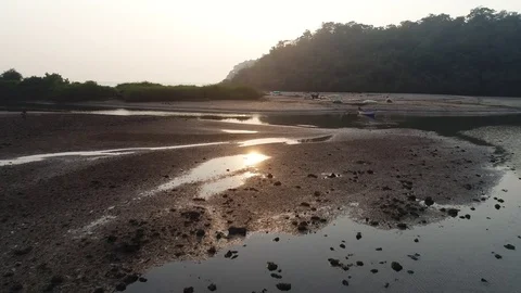 Sunset on a small shallow river. Sun reflected on clear water. Aerial view. Stock-Footage 85176697