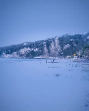 Sunset on a snow-covered beach 스톡 사진