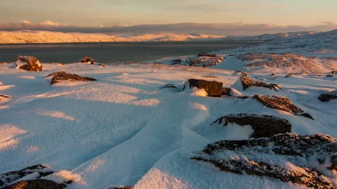 Sunset on the snow-covered shore of the Barents Sea Stock-Footage 97297834