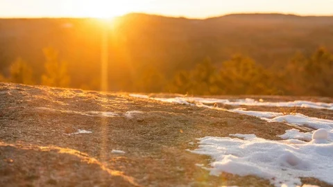 Sunset snow melt on rock Stock Footage 100138431