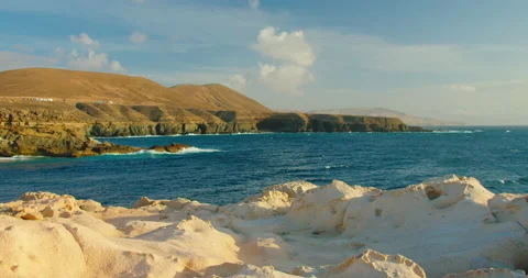 Sunset soft light on rocky volcanic coastline of little resort city Ajuy, Playa Stock Footage 201974261