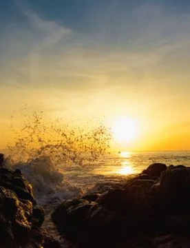Sunset splashing waves Stock Photos