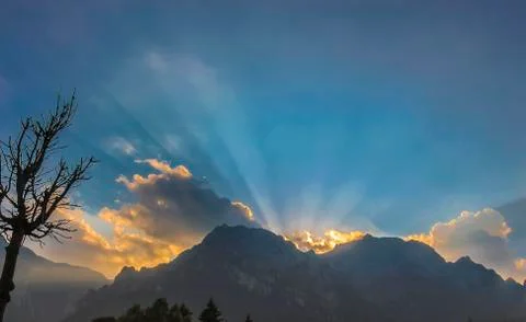 Sunset splintered light radiates over mountain in Brasov, Romania Stock Photos