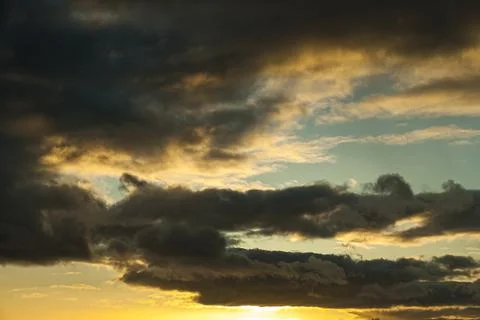 Sunset in springtime with golden light and stormy stratocumulus cloud Stock Photos