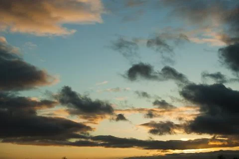 Sunset in springtime with golden light and stormy stratocumulus cloud Stock Photos