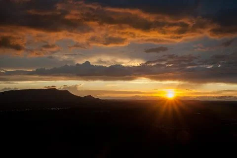 Sunset Star over Mountain Range Stock Photos