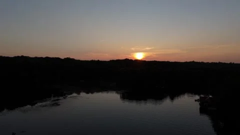 Sunset starting on lake then going p to reveal sunset Stock Footage 251565027