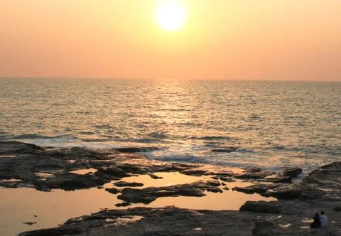 Sunset on the stone beach Stock Photos