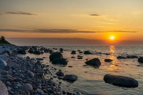 Sunset at stony beach Stock Photos
